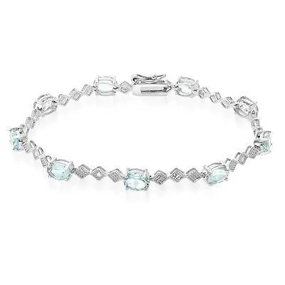 9 CARAT OVAL BLUE TOPAZ AND DIAMOND BRACELET IN RHODIUM PLATED BRASS