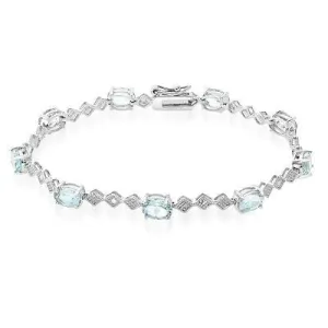 9 CARAT OVAL BLUE TOPAZ AND DIAMOND BRACELET IN RHODIUM PLATED BRASS