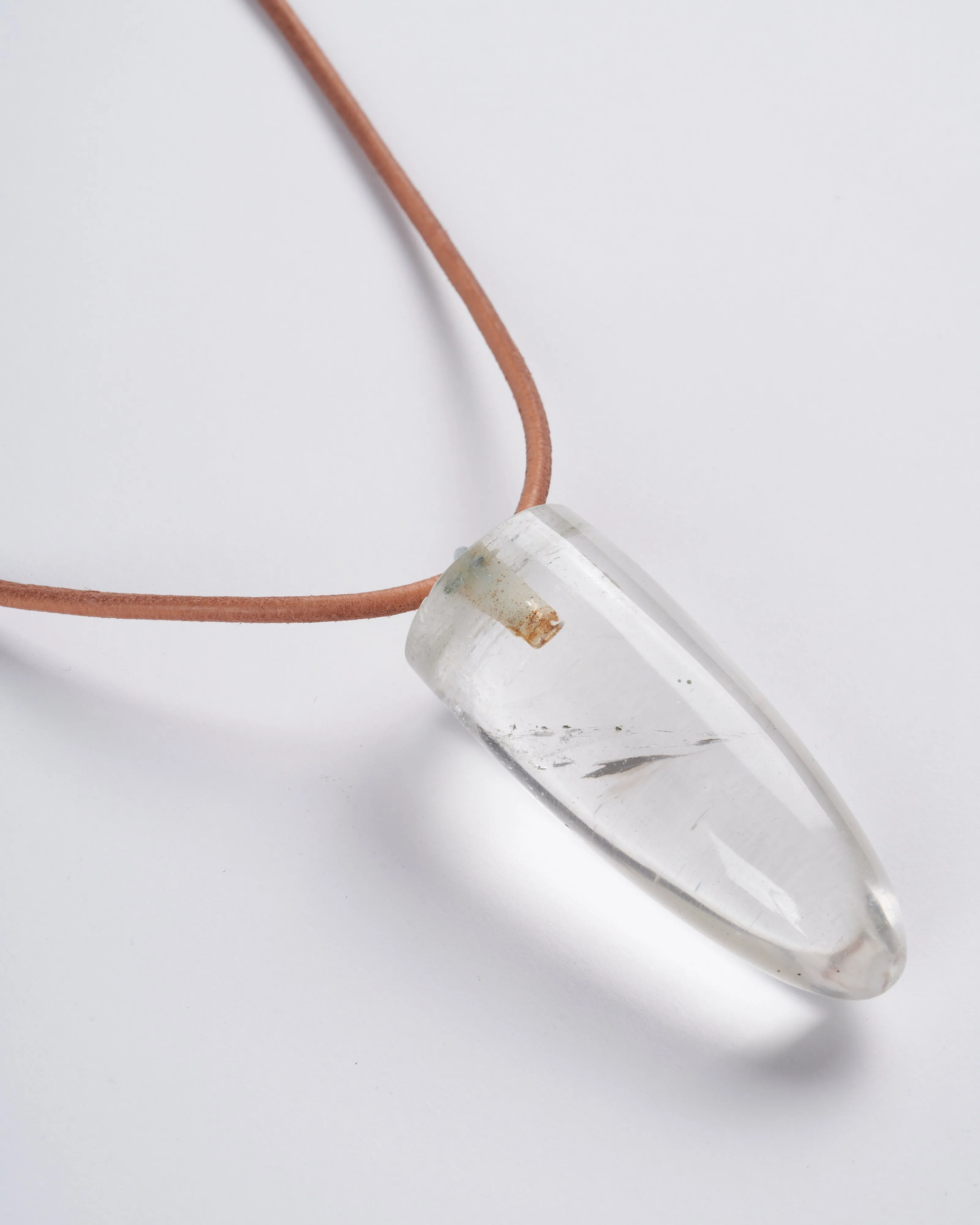 rock crystal bullet with eye pin on leather - stone clear