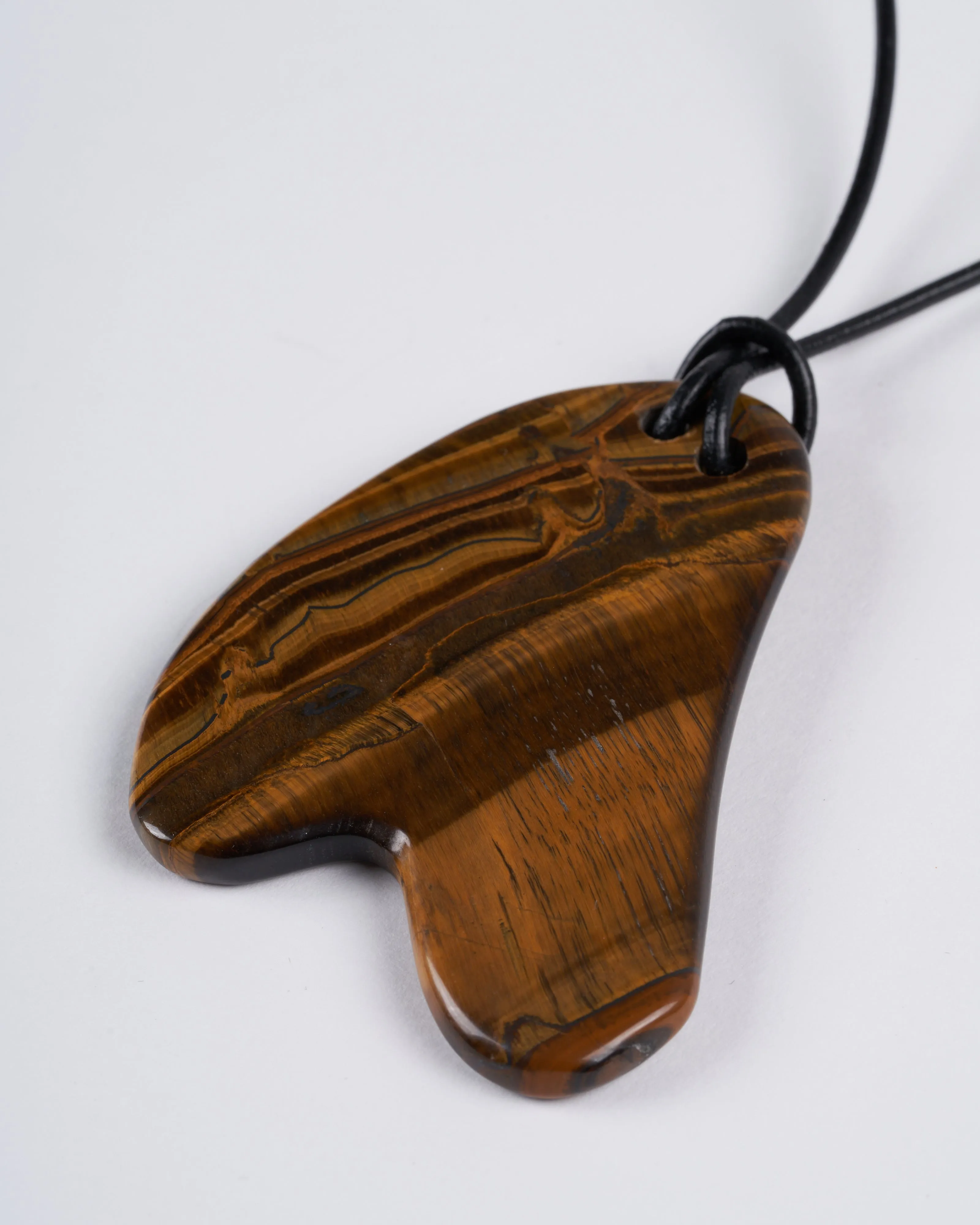 tigers eye plaque on leather - stone brown